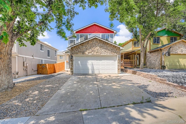 8057 Bryant St, Westminster, CO 80031 - view of front of house featuring stone siding and concrete driveway