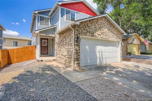 8057 Bryant St, Westminster, CO 80031 - view of front of property with stone siding, an attached garage, and driveway