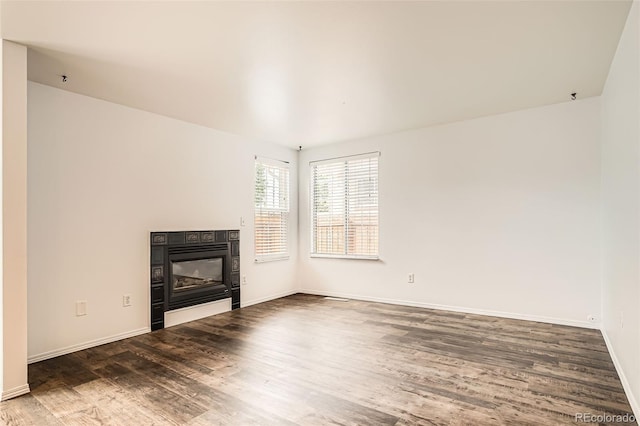 8057 Bryant St, Westminster, CO 80031 - unfurnished living room featuring wood finished floors and a tiled fireplace