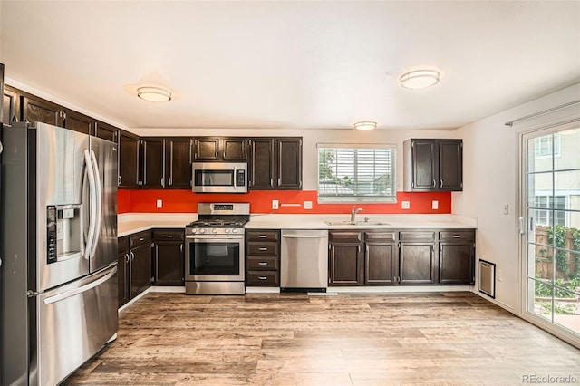 8057 Bryant St, Westminster, CO 80031 - kitchen with stainless steel appliances, light countertops, light wood-style floors, and plenty of natural light