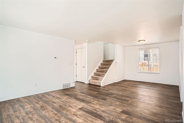 8057 Bryant St, Westminster, CO 80031 - spare room with stairway and dark wood finished floors