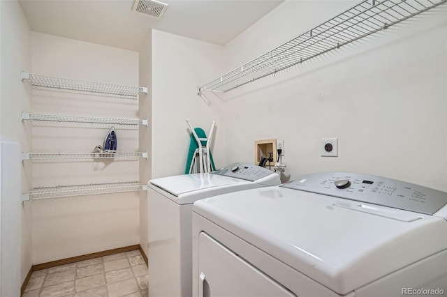 8057 Bryant St, Westminster, CO 80031 - washroom featuring washer and clothes dryer and light stone finish floors