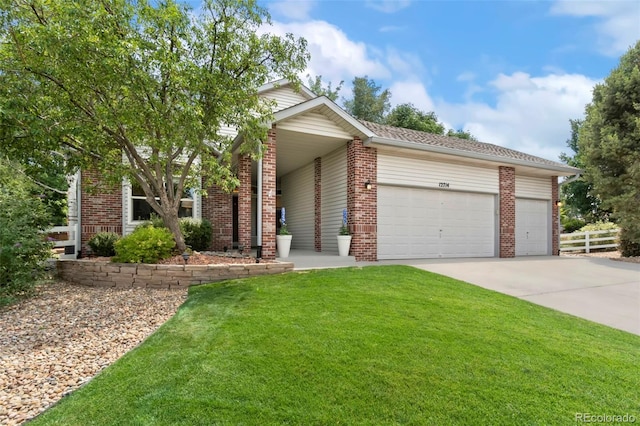 view of front of home with fence, concrete driveway, a front lawn, a garage, and brick siding