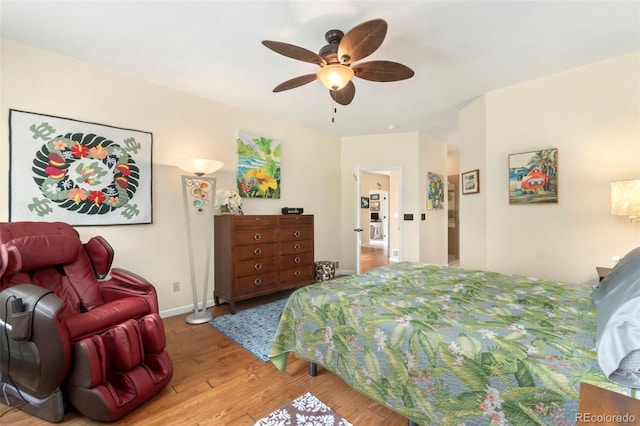 bedroom featuring ceiling fan, baseboards, and wood finished floors