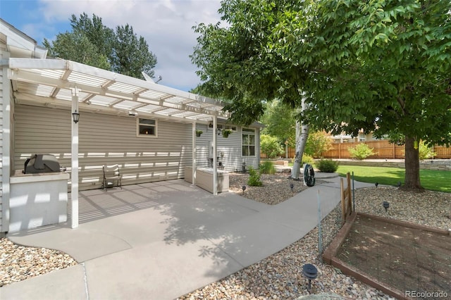 view of patio with a pergola and fence