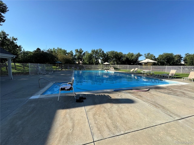 community pool featuring a patio and fence