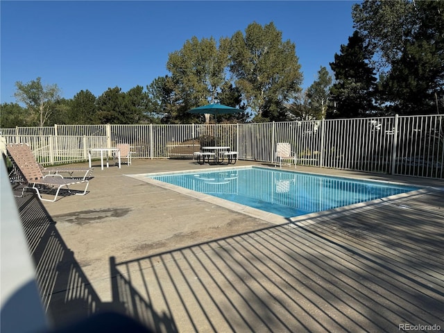 view of pool with a fenced in pool, fence, and a patio area