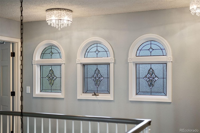 interior details with an inviting chandelier and a textured ceiling