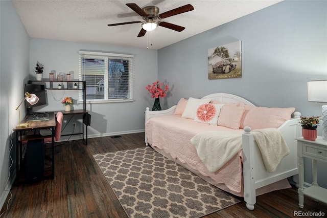 bedroom featuring a textured ceiling, wood finished floors, baseboards, and ceiling fan