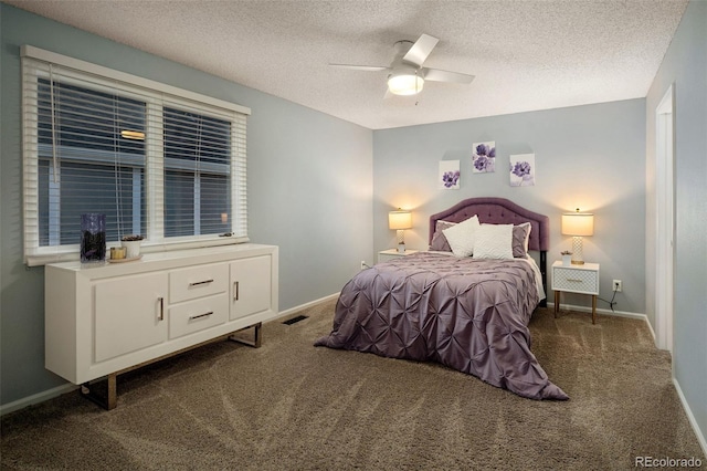 bedroom featuring visible vents, baseboards, carpet, a textured ceiling, and a ceiling fan