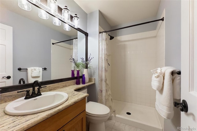 full bath featuring toilet, vanity, and a tile shower