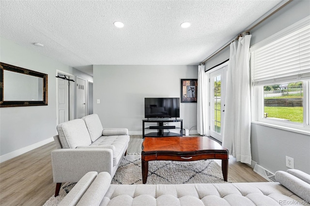9175 Cole Dr, Arvada, CO 80004 - living area with a textured ceiling and wood finished floors