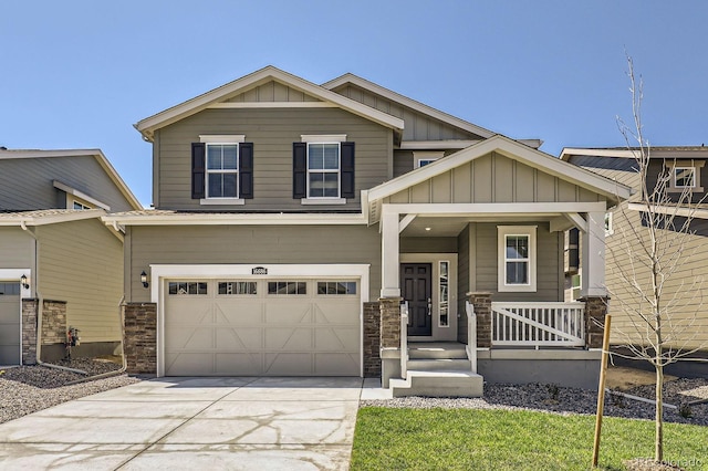 craftsman inspired home with an attached garage, stone siding, board and batten siding, a porch, and concrete driveway