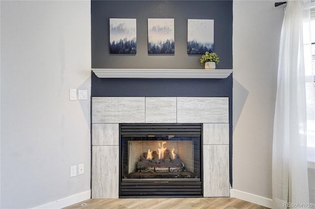 6840 Goldcrest Ct, Colorado Springs, CO 80919 - detailed view of wood finished floors, a tile fireplace, and baseboards
