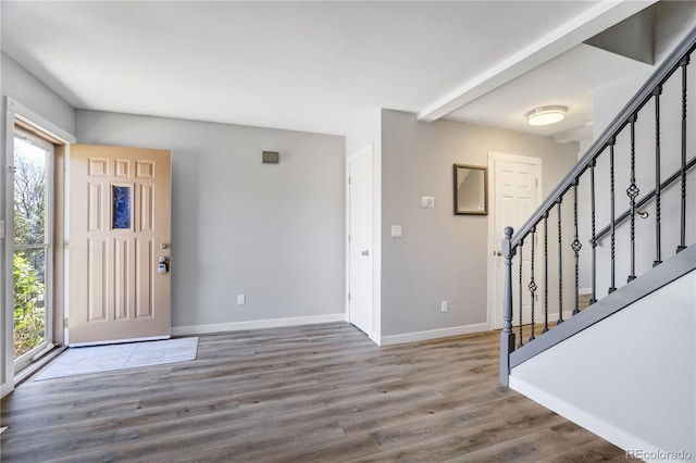6840 Goldcrest Ct, Colorado Springs, CO 80919 - foyer entrance with healthy amount of natural light, stairway, baseboards, and wood finished floors