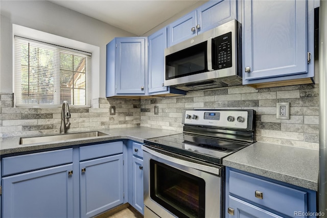 6840 Goldcrest Ct, Colorado Springs, CO 80919 - kitchen with appliances with stainless steel finishes, a sink, blue cabinets, and tasteful backsplash