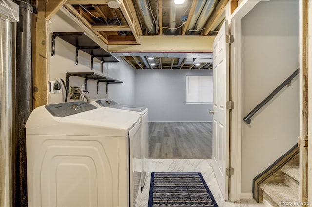 6840 Goldcrest Ct, Colorado Springs, CO 80919 - laundry area featuring independent washer and dryer, baseboards, and wood finished floors