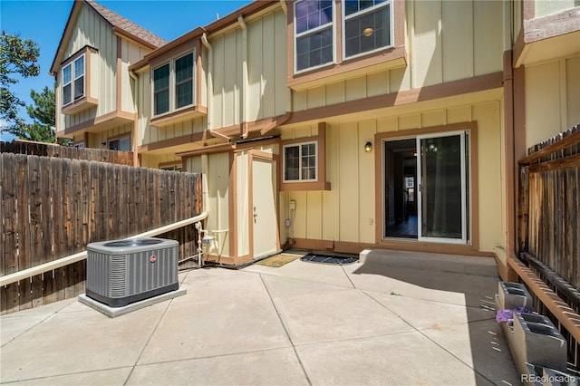 6840 Goldcrest Ct, Colorado Springs, CO 80919 - rear view of property featuring central air condition unit, a patio, board and batten siding, and fence