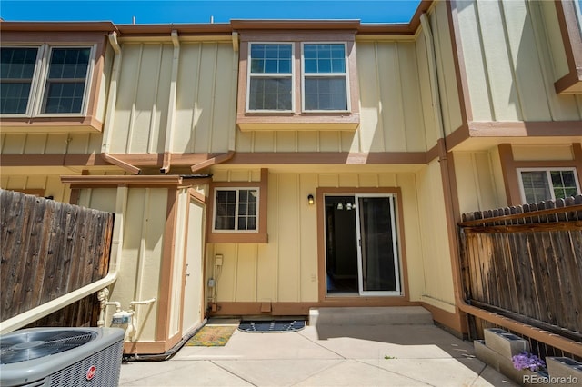 6840 Goldcrest Ct, Colorado Springs, CO 80919 - rear view of house featuring central air condition unit, a patio area, fence, and board and batten siding