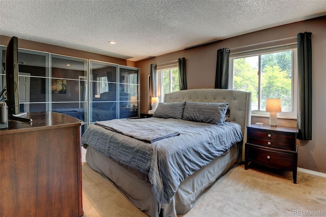 6775 Coors Ct, Arvada, CO 80004 - bedroom featuring light carpet, a textured ceiling, and recessed lighting