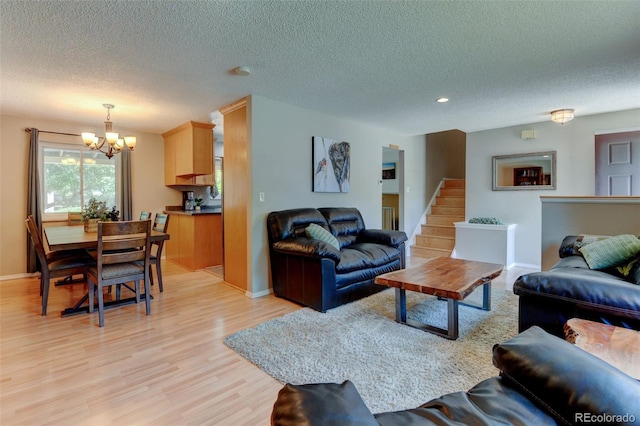 6775 Coors Ct, Arvada, CO 80004 - living room with a chandelier, light wood-style flooring, a textured ceiling, recessed lighting, and stairs