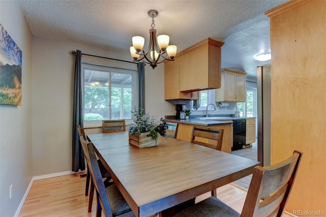 6775 Coors Ct, Arvada, CO 80004 - dining room with a textured ceiling, a chandelier, and light wood-style floors