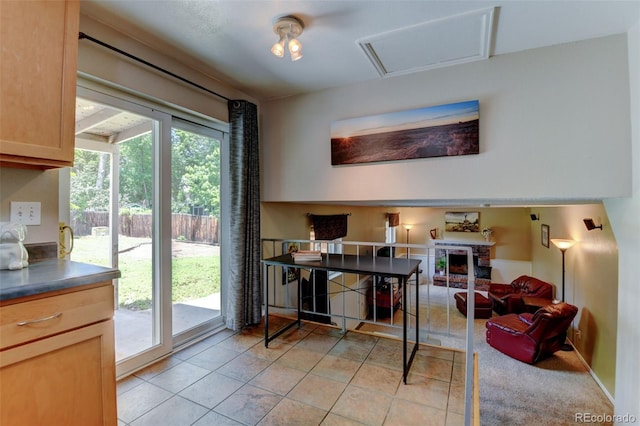 6775 Coors Ct, Arvada, CO 80004 - dining space with a fireplace and light tile patterned floors