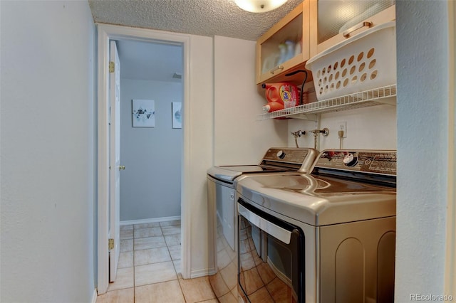 6775 Coors Ct, Arvada, CO 80004 - laundry room with washing machine and clothes dryer, light tile patterned flooring, and a textured ceiling