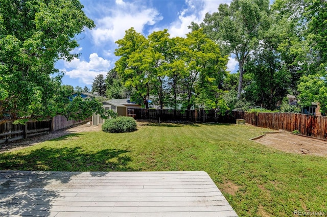 6775 Coors Ct, Arvada, CO 80004 - fenced backyard featuring a deck and view of scattered trees