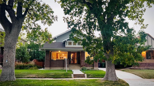 view of property hidden behind natural elements featuring a front yard