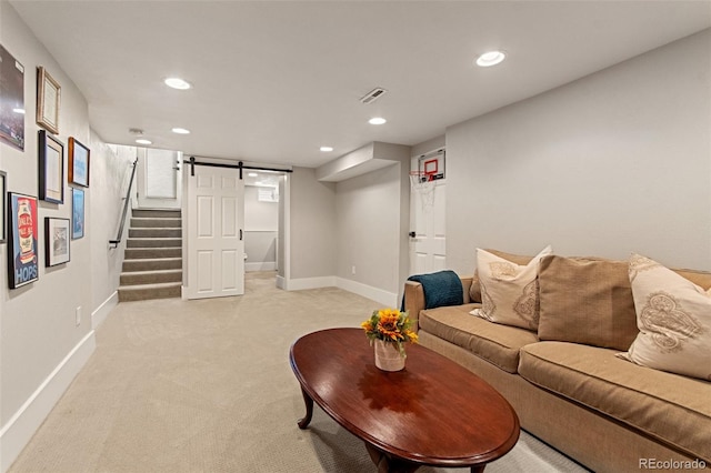 carpeted living room with a barn door