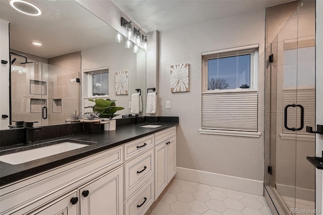 bathroom with tile patterned flooring, vanity, and an enclosed shower