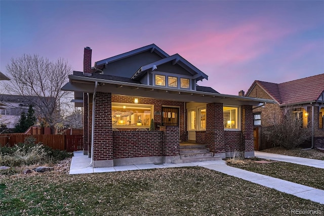 view of front facade featuring a porch and a lawn