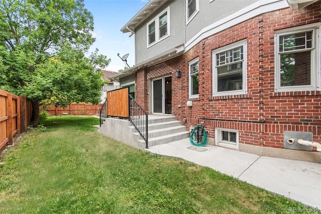 rear view of property featuring a lawn