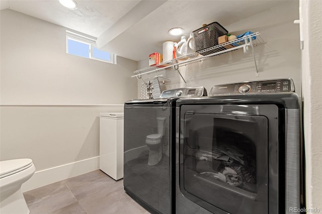 clothes washing area with washer and clothes dryer