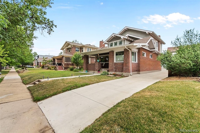 craftsman inspired home with a carport and a front lawn