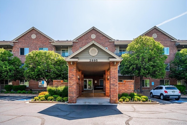 2895 W Riverwalk Cir Unit 104, Littleton, CO 80123 - view of building exterior featuring uncovered parking