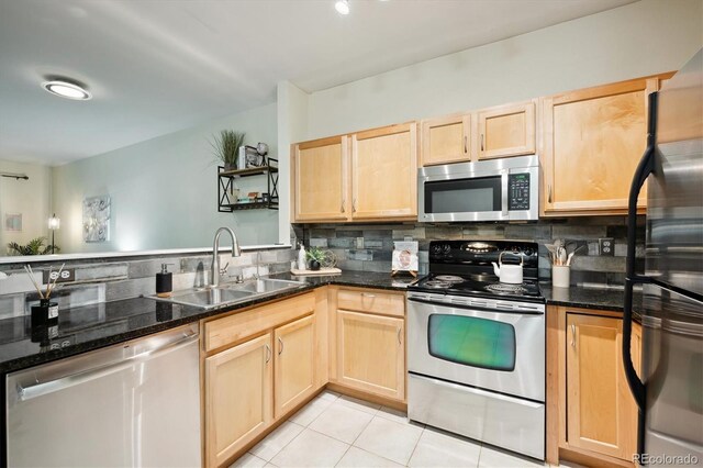 2895 W Riverwalk Cir Unit 104, Littleton, CO 80123 - kitchen with appliances with stainless steel finishes, a sink, light brown cabinets, backsplash, and light tile patterned flooring