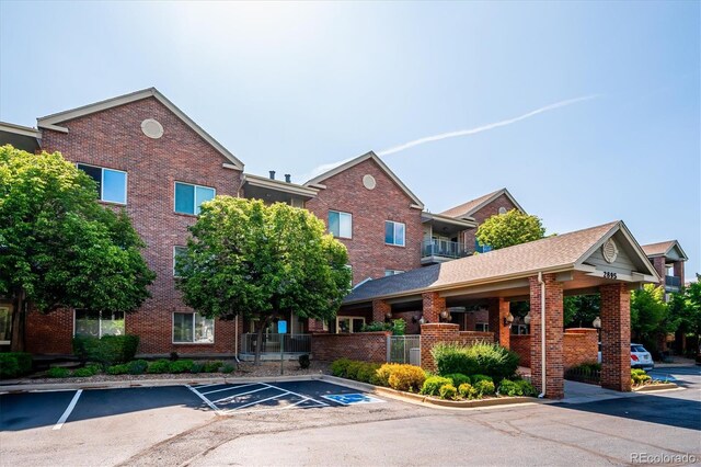 2895 W Riverwalk Cir Unit 104, Littleton, CO 80123 - view of property with uncovered parking