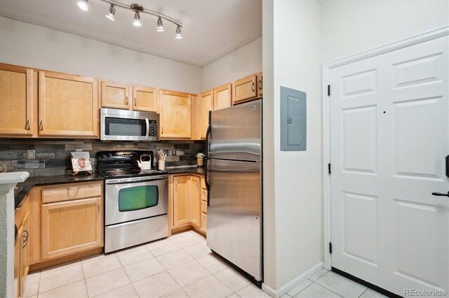 2895 W Riverwalk Cir Unit 104, Littleton, CO 80123 - kitchen featuring appliances with stainless steel finishes, electric panel, light brown cabinetry, light tile patterned floors, and backsplash