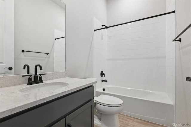 full bath with vanity, bathing tub / shower combination, wood finished floors, and toilet