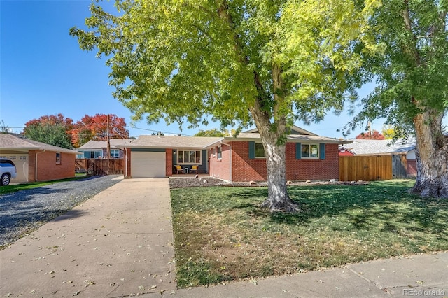 ranch-style home featuring a front yard and a garage