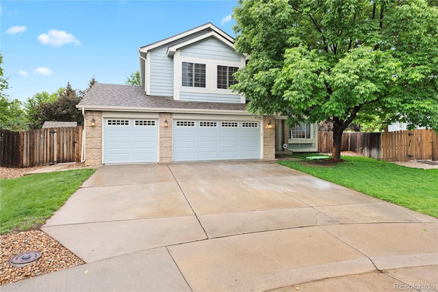 9756 Quay Loop, Broomfield, CO 80021 - view of front of home featuring brick siding, concrete driveway, a shingled roof, and a garage