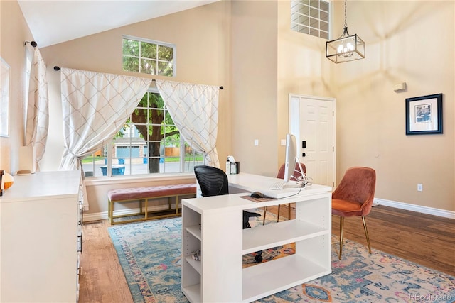 9756 Quay Loop, Broomfield, CO 80021 - office featuring high vaulted ceiling, wood finished floors, baseboards, and a chandelier