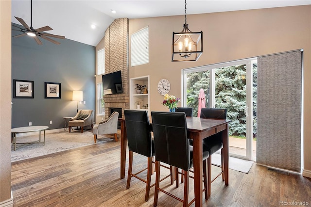 9756 Quay Loop, Broomfield, CO 80021 - dining area featuring wood finished floors, plenty of natural light, high vaulted ceiling, a ceiling fan, and a chandelier