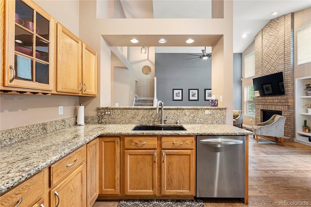 9756 Quay Loop, Broomfield, CO 80021 - kitchen with dishwasher, a sink, light stone counters, glass insert cabinets, and ceiling fan