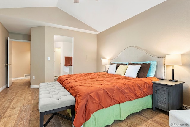 9756 Quay Loop, Broomfield, CO 80021 - bedroom featuring vaulted ceiling, light wood-style floors, and baseboards