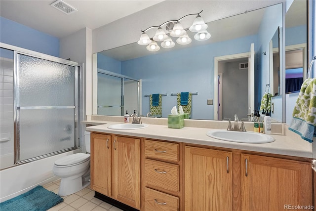 9756 Quay Loop, Broomfield, CO 80021 - full bath featuring double vanity, toilet, shower / bath combination with glass door, and tile patterned floors