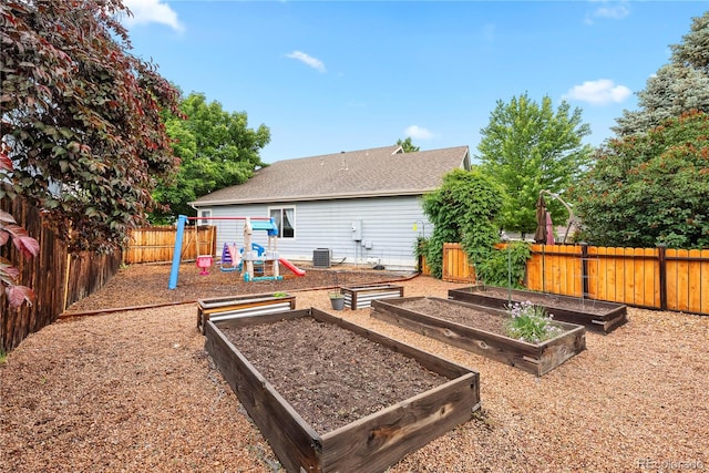 9756 Quay Loop, Broomfield, CO 80021 - back of property featuring a playground, central air condition unit, a vegetable garden, and a fenced backyard