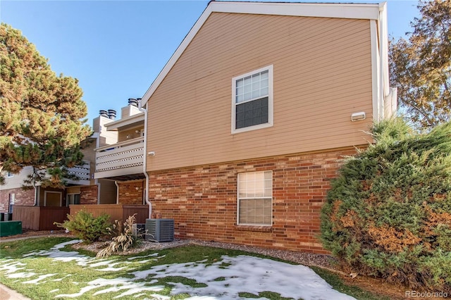 view of side of home with a balcony and central AC